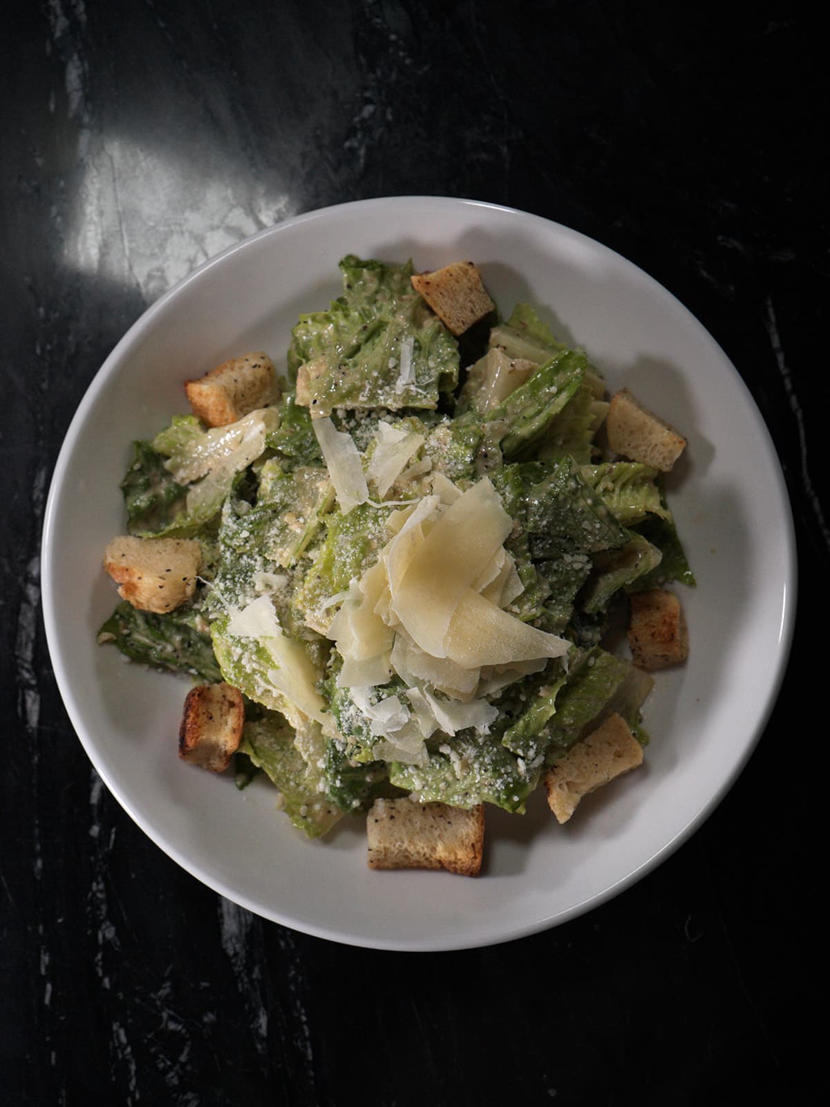 Caesar salad with shaved parmesan and croutons
